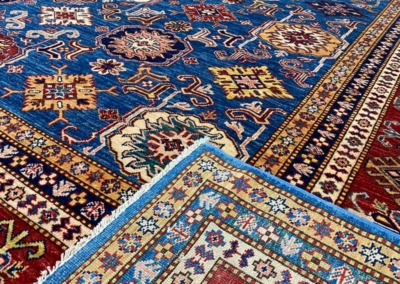 Kazak blue base with red border rug front and back