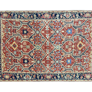 This bold tribal area rug is 9x12 featuring large tribal geometric shapes with bold red, blue and multicolored tones. This rug is hand knotted with wool.