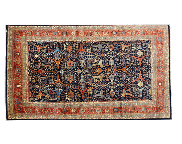 Bold large rug with navy and rust tones and a red and gold border. This area rug is hand-knotted with wool.