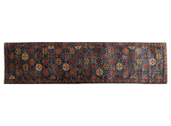 Long 3x10 area rug runner with deep blues, orange, and yellows. This rug features a geometric pattern with a border and short fringe.
