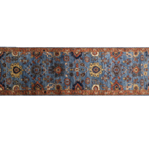 Long 3x10 area rug runner with a blue background and orange and yellows geometric designs. This rug features a border and short fringe.