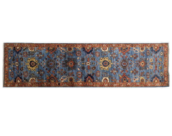 Long 3x10 area rug runner with a blue background and orange and yellows geometric designs. This rug features a border and short fringe.