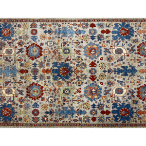 Bright and bold 6x9 area rug with blue and red tones. This area rug is hand-knotted with wool.