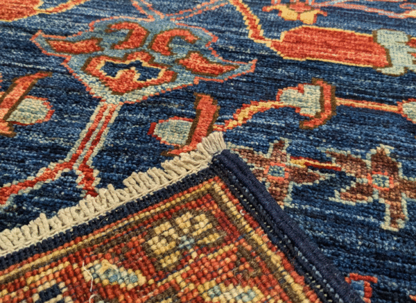 Bold long 3x10 area rug runner with a deep blue background, yellow, and red tribal designs. This rug features a geometric pattern with a border and short fringe.