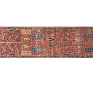 Aryana 3x10 area rug with a red background and tribal yellow and blue designs. This rug is hand-knotted with wool.