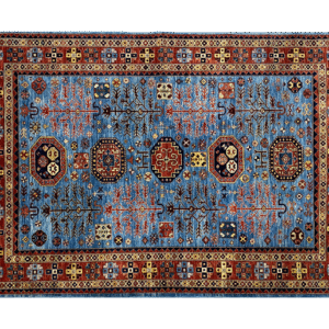 This bold tribal area rug is 6x9 featuring a blue background with tribal geometric shapes with a tribal styled border and short fringe.
