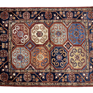 Bold fun large rug with white and blue tones and a navy border. This area rug is hand-knotted with wool.