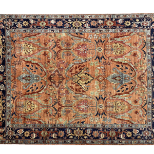 Bold fun large rug with red and rust tones and a dark navy border. This area rug is hand-knotted with wool.