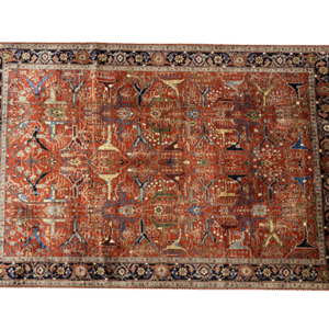 Bold large rug with red and rust tones and a navy border. This area rug is hand-knotted with wool.
