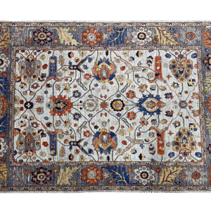 Large 8x10 tribal area rug with a blue background and multicolored tribal designs with a large border. This area rug is hand-knotted with wool.