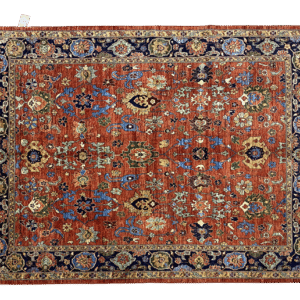 Bold fun large rug with red and rust tones and a dark navy border. This area rug is hand-knotted with wool.
