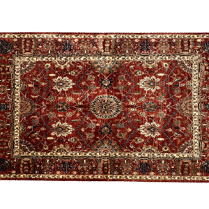 Large 8x10 tribal area rug with a red background and multicolored tribal designs with a large border. This area rug is hand-knotted with wool.