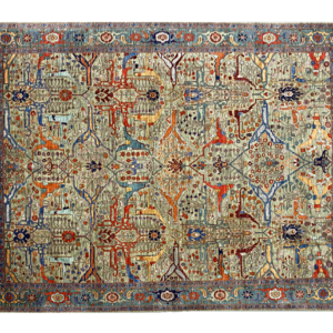 Large tribal 8x10 area rug with a green background and multicolored tribal designs with a large border. This area rug is hand-knotted with wool.