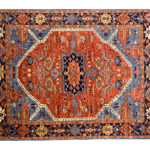 Stunning bold 8x10 area rug featuring a large center design. This rug features red, blue and yellow.