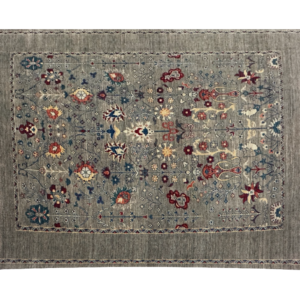 Transitional area rug with tribal designs and short fringe.