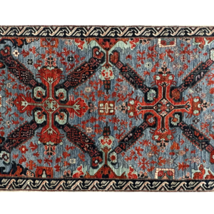 Stunning 4 x 6 area rug with striking tribal design in blue and red.
