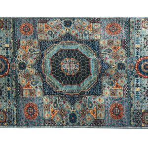 Small tribal area rug with a center medallion in blue and rust.