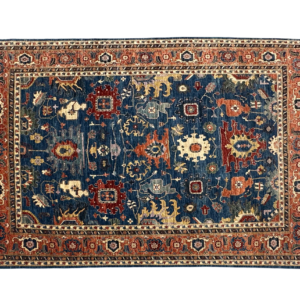 Tribal 8 x 10 area rug with navy and red tones. This rug is hand-knotted with wool.