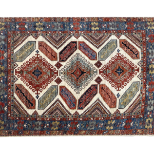Large stunning 8 x 10 area rug with a multicolored tribal designs. This rug is hand-knotted with wool.