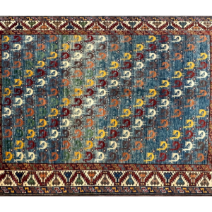 Stunning 5 x 7 area rug with a bright blue background and multicolored tribal designs. This area rug is hand-knotted with wool.