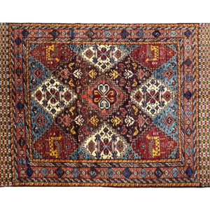 Stunning 5 x 7 area rug with a bright blue background and multicolored tribal designs. This area rug is hand-knotted with wool.
