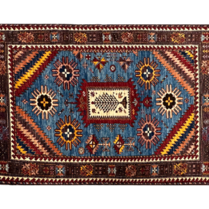 Stunning 4 x 6 area rug with a bright blue background and multicolored tribal designs. This area rug is hand-knotted with wool.