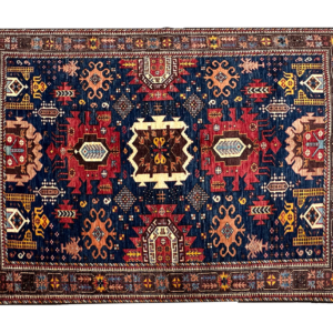 Stunning 6 x 8 area rug with a blue background and multicolored designs. This area rug is hand-knotted with wool.
