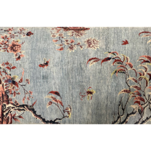 Stunning 8 x 10 area rug with trees and bird designs. This rug is hand-knotted with wool.