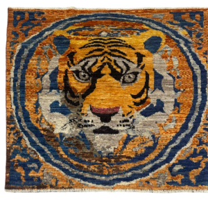 Small artistic area rug or wall hanging featuring a tiger. Hand-knotted with wool.
