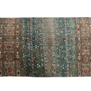 Tribal styled area rug with green and rust tribal designs. This area rug is hand-knotted with wool.