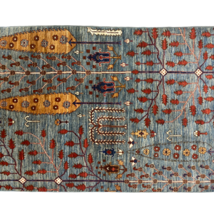 Add a touch of fall to your home with this blue area rug with trees.