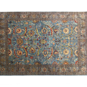 Stunning 9 x 12 area rug with tribal designs. Hand-knotted with wool.