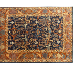 Tribal 8 x 10 area rug with a navy background and gold border.
