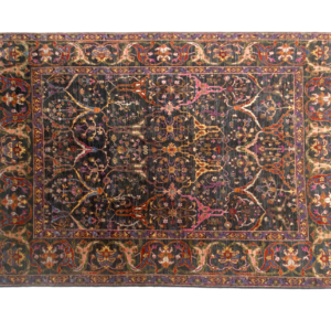 Large 8 x 10 area rug with tribal designs and a border. Hand-knotted with wool.