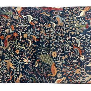 Statement area rug with birds of paradise on a blue background. This rug is hand-knotted with wool.