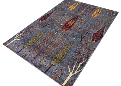 Luri blue base tribal rug with trees angle